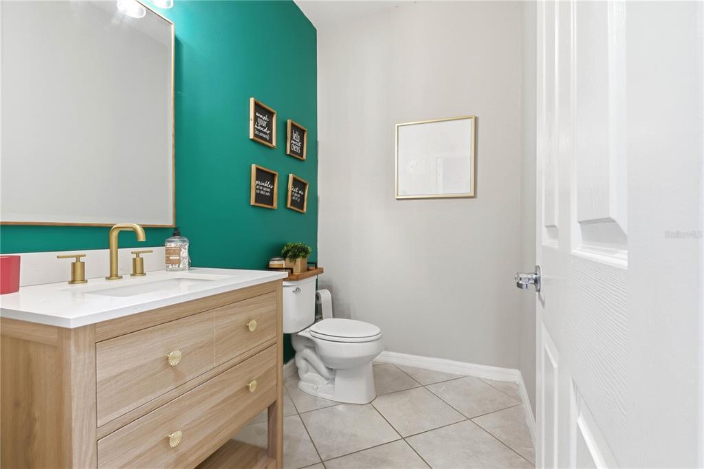 A bathroom features a teal accent wall, a light wood vanity, and a white toilet — 11624 KILKENNY CORAL DRIVE, RIVERVIEW, FL