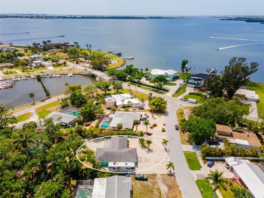 An aerial view shows a residential house with a large driveway and an RV parked outside — 1133 MONTEZUMA DRIVE, BRADENTON, FL