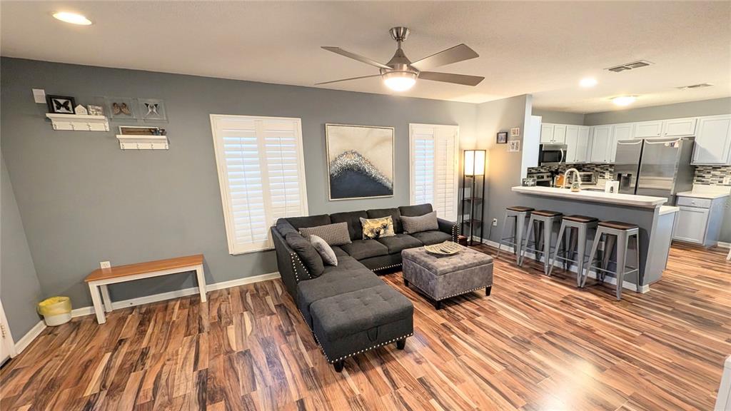 A screened-in patio features a round metal dining set, two outdoor grills, and a swimming pool — 2976 KOKOMO LOOP, HAINES CITY, FL