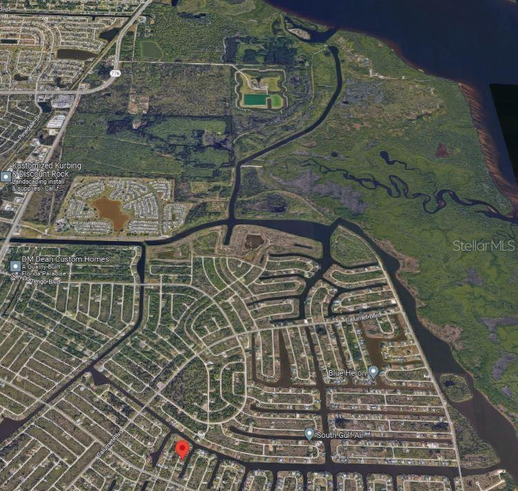 This is an aerial map view of a residential neighborhood with canals and surrounding wetlands — 9270 MELODY CIRCLE, PORT CHARLOTTE, FL
