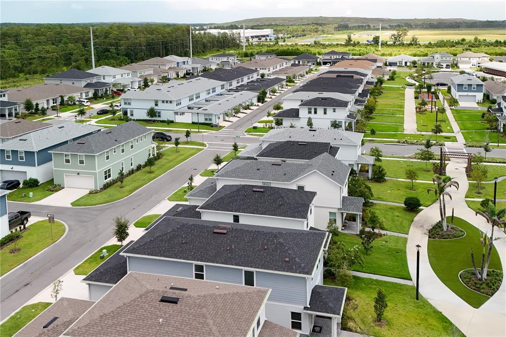 An aerial view shows a suburban neighborhood with multiple houses, paved streets, and green lawns — 10922 FELICITY ALLEY, ORLANDO, FL