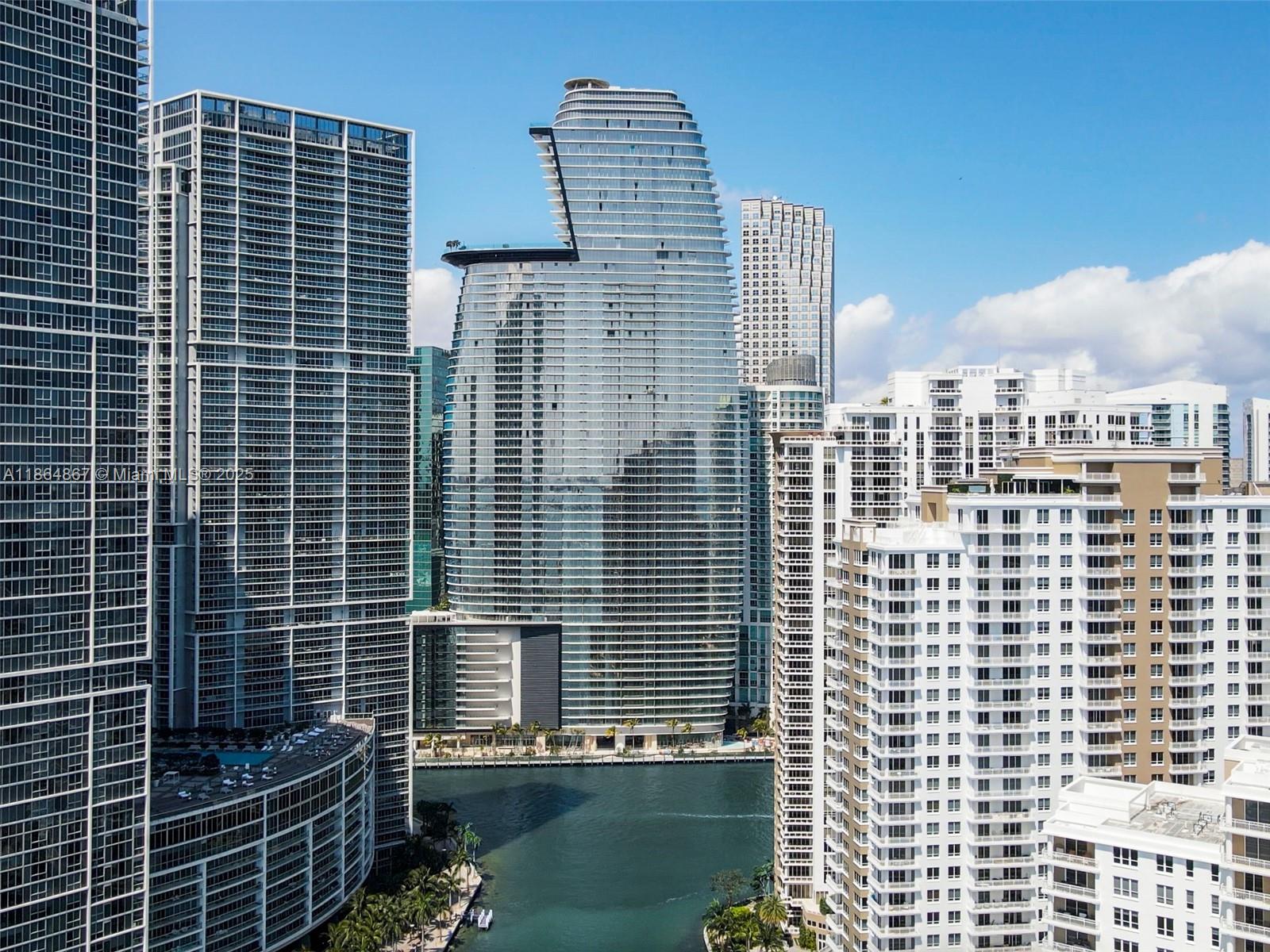 An exterior view of modern high-rise apartment buildings surrounding a canal in Miami — 300 Biscayne Blvd Way # 2505, Miami FL 33131, MIAMI, FL