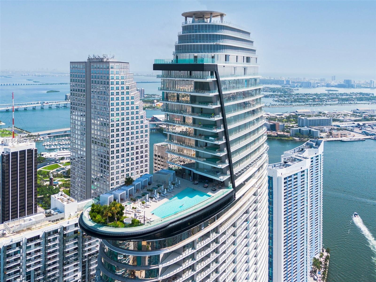 An aerial view of a high-rise building featuring a large cantilevered swimming pool and terrace — 300 Biscayne Blvd Way # 2505, Miami FL 33131, MIAMI, FL