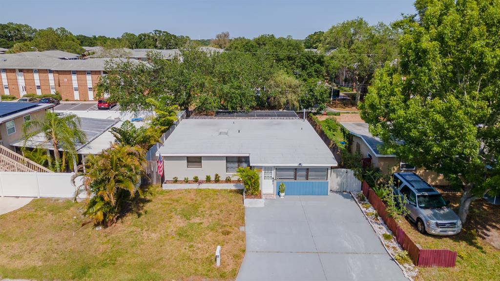 An aerial view shows a single-story house with a flat roof, driveway, and front yard — 11919 102ND STREET, LARGO, FL
