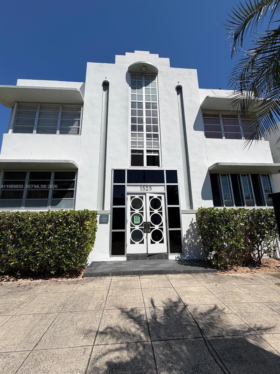 A white Art Deco building features a central glass-paneled tower and a decorative double door — 1525 Meridian Ave # 108, Miami Beach FL 33139, MIAMI BEACH, FL