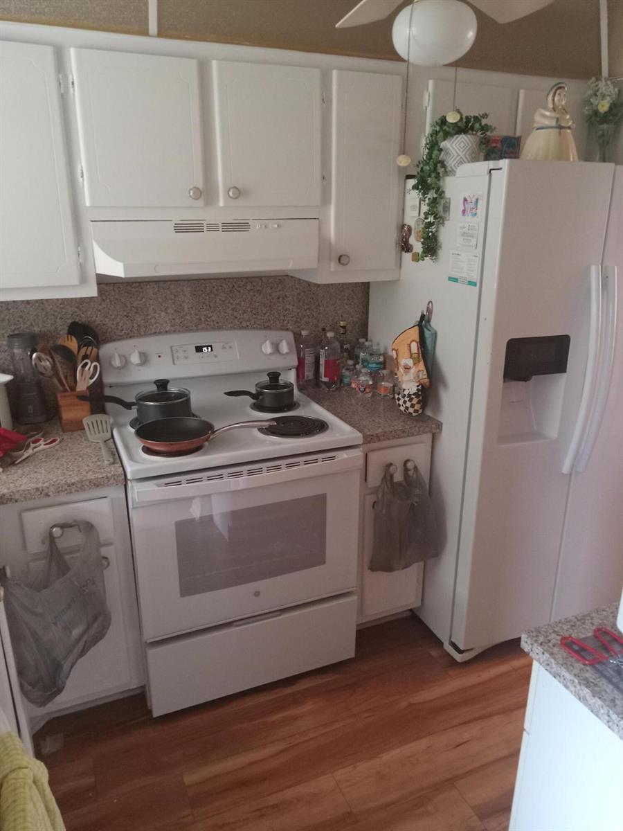 A kitchen features white cabinets, a white electric stove, and a white refrigerator — 2901 E Sunrise Lakes Drive E # 202, Sunrise FL 33322, SUNRISE, FL
