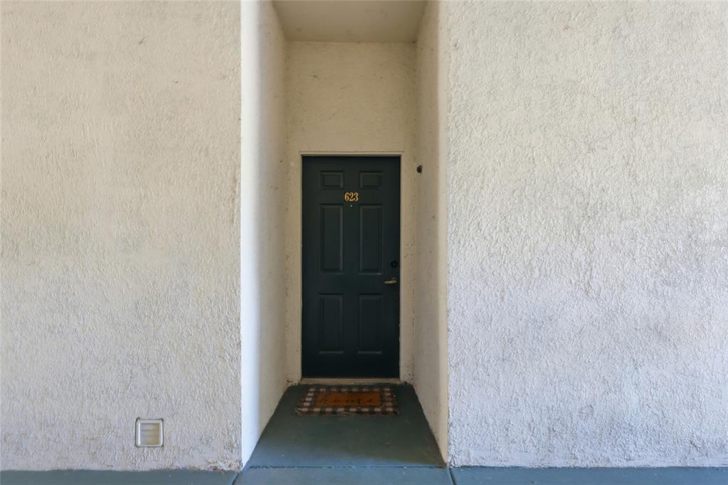 A dark green front door with the number 623 is set in a stucco alcove — 17106 CARRINGTON PARK DRIVE UNIT 623, TAMPA, FL