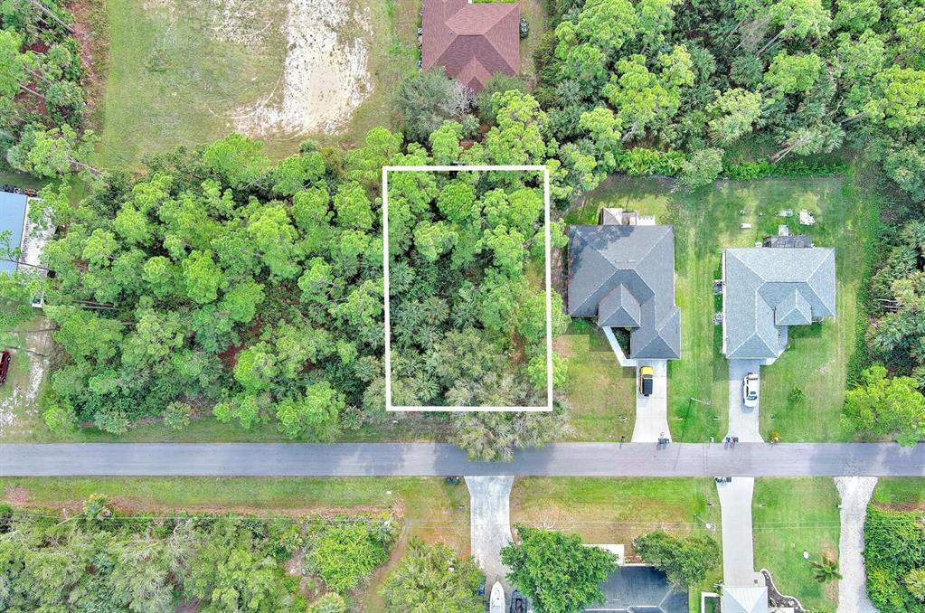 An aerial view shows a rectangular wooded lot situated between two residential houses — 3847 HIGHLIGHT STREET, FORT MYERS, FL