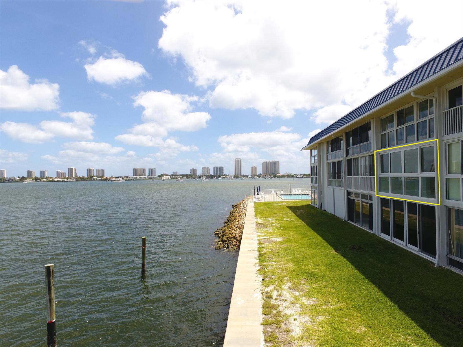 An exterior view of a waterfront building with a highlighted second-story window section — 400 Wilma Circle # 207, Riviera Beach FL 33404, RIVIERA BEACH, FL