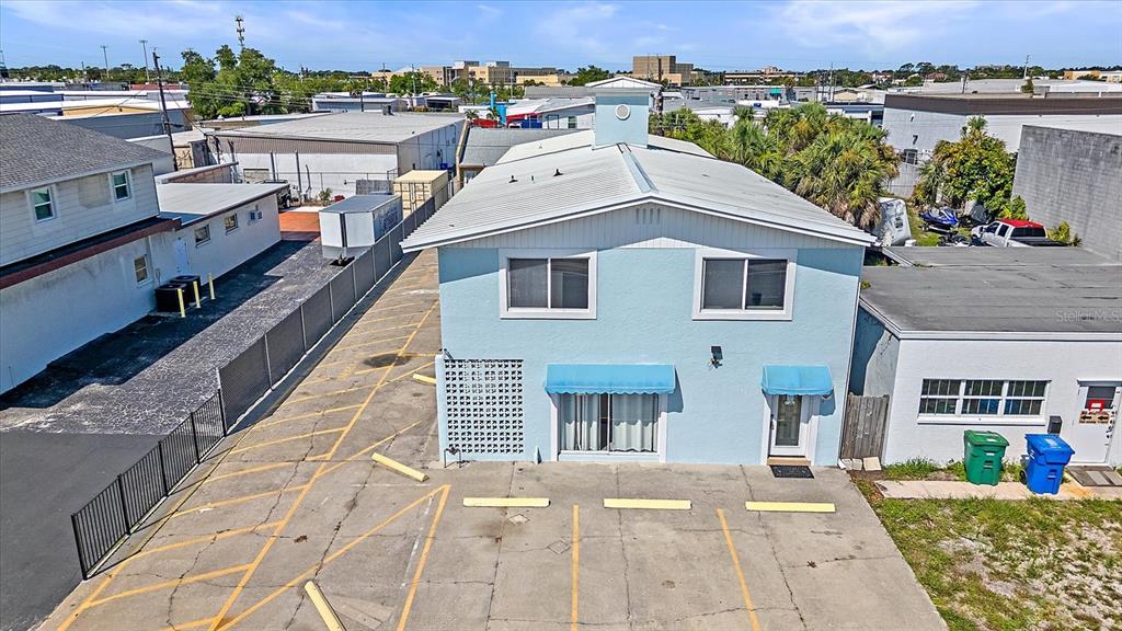 An aerial view shows a light blue two-story building with a parking lot in front — 236 GROVE STREET S, VENICE, FL