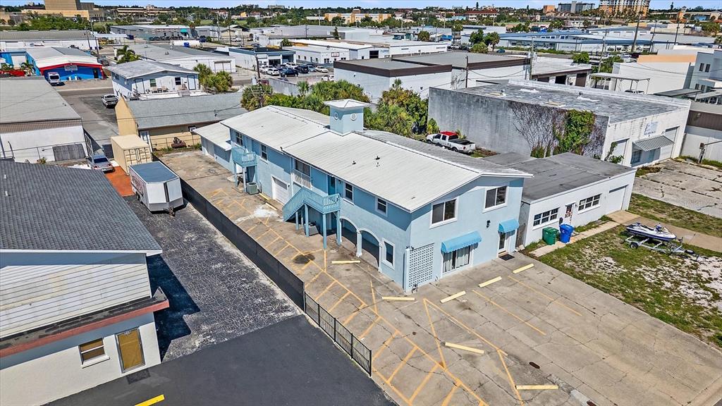 An aerial view shows a light blue two-story commercial building with a parking lot — 236 GROVE STREET S, VENICE, FL
