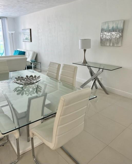 A dining area features a glass table, white chairs, and a glass console table — 3801 S Ocean Dr # 3C, Hollywood FL 33019, HOLLYWOOD, FL