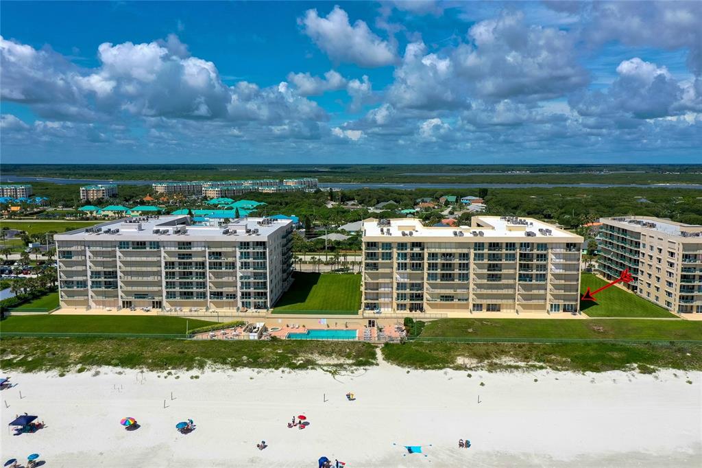 An aerial view of beachfront condominium buildings with a swimming pool and sandy beach — 4565 S ATLANTIC AVENUE UNIT 5204, PONCE INLET, FL