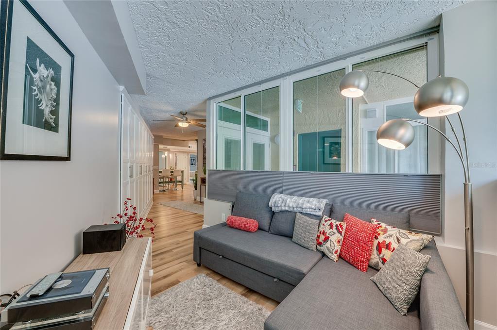 A living room features a grey sectional sofa, a floor lamp, and a hallway view — 4565 S ATLANTIC AVENUE UNIT 5204, PONCE INLET, FL
