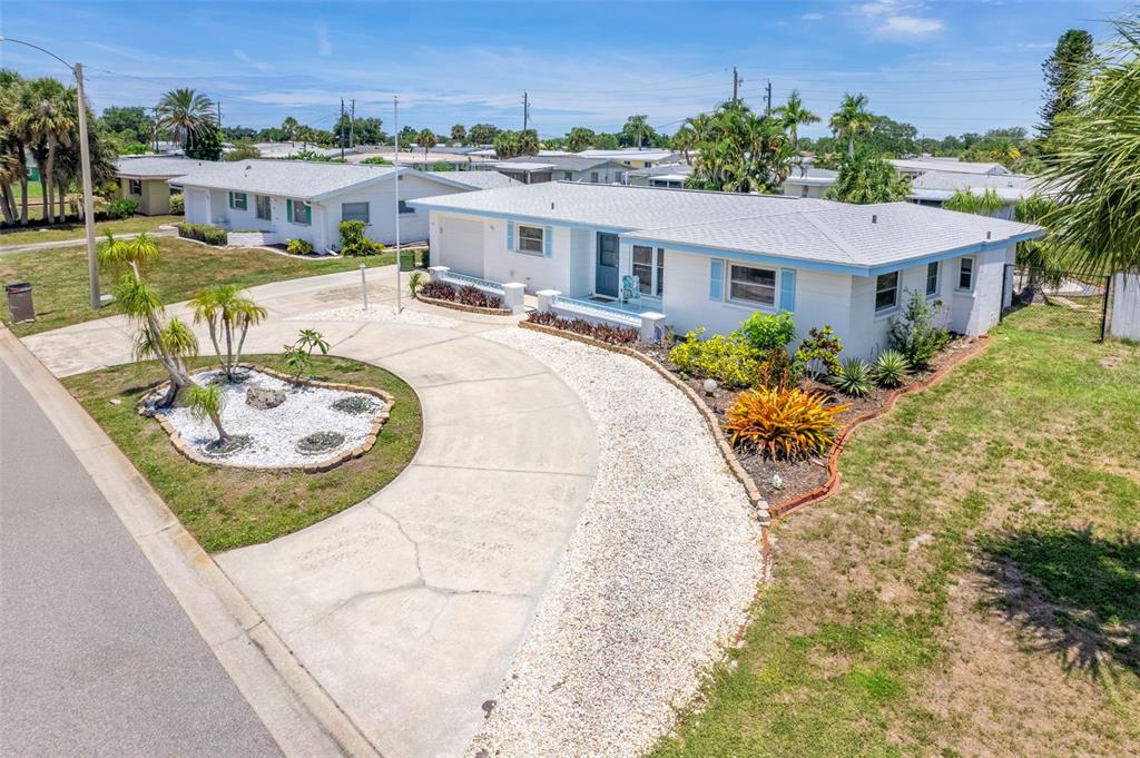 A white single-story house features a curved concrete driveway and a gravel front yard — 531 SHERIDAN DRIVE, VENICE, FL