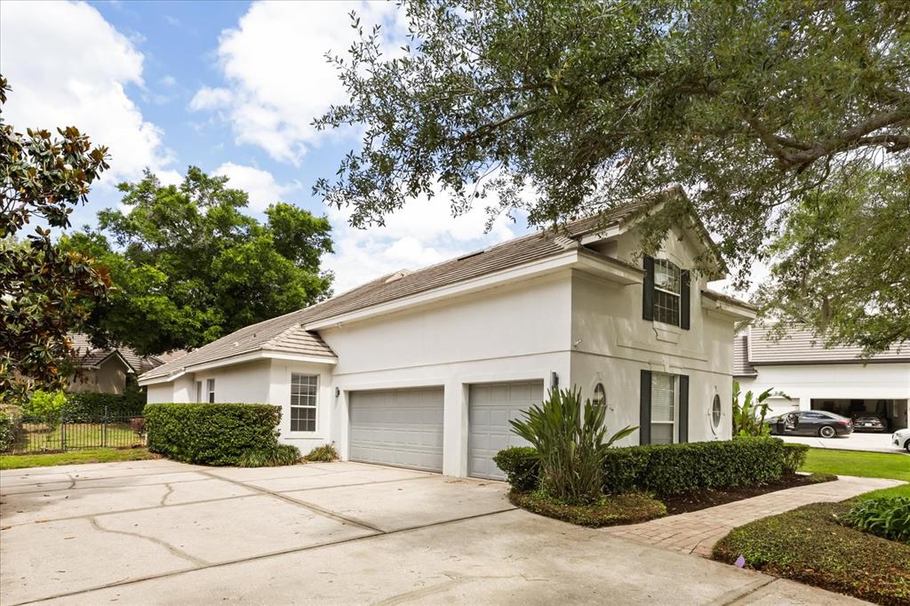 A two-story white house with a two-car garage and a concrete driveway — 987 BRIGHTWATER CIRCLE, MAITLAND, FL