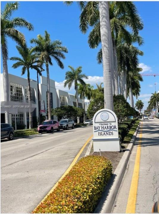 A street scene featuring a welcome sign for Bay Harbor Islands lined with palm trees — BAY HARBOR ISLANDS, FL