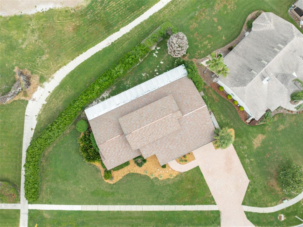 An aerial view shows a residential house with a shingled roof and a paved driveway — 6151 SILVER OAKS DRIVE, ZEPHYRHILLS, FL