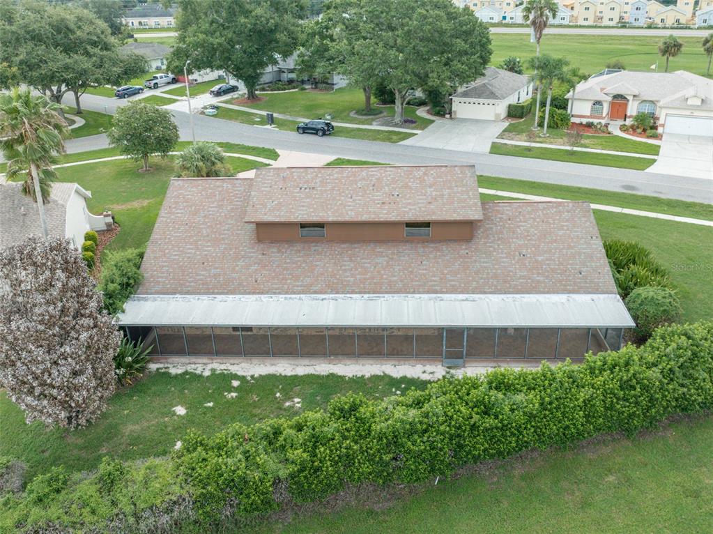 An aerial view shows a house with a brown shingled roof and a screened-in porch — 6151 SILVER OAKS DRIVE, ZEPHYRHILLS, FL