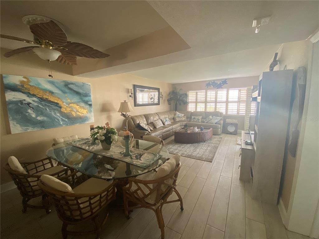 A dining area with a glass table and a living room with a sectional sofa — 4175 S ATLANTIC AVENUE UNIT 3160, NEW SMYRNA BEACH, FL