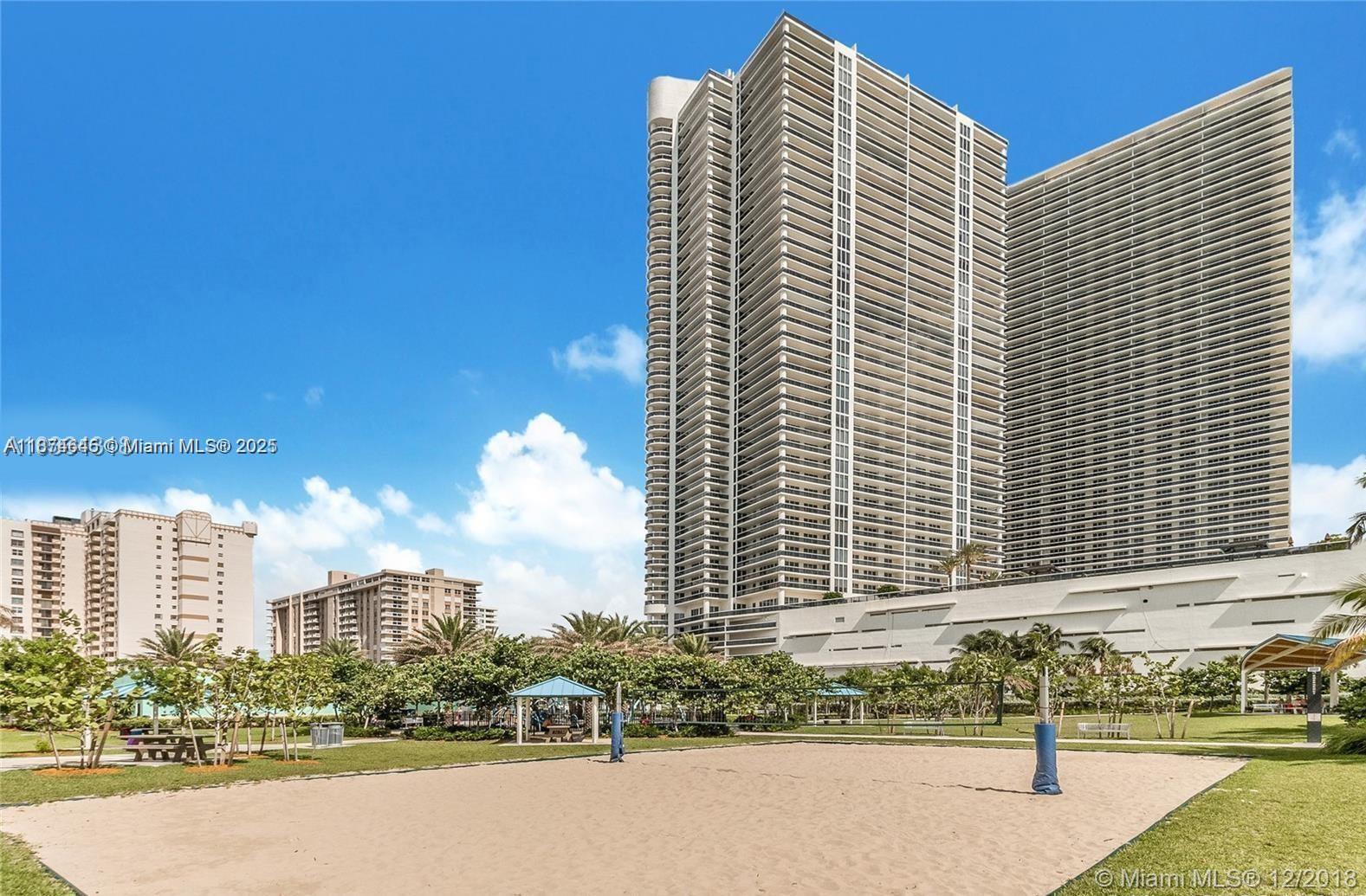 A sandy volleyball court sits in front of two tall residential high-rise buildings — 1830 S Ocean Dr # 4107, Hallandale Beach FL 33009, HALLANDALE BEACH, FL
