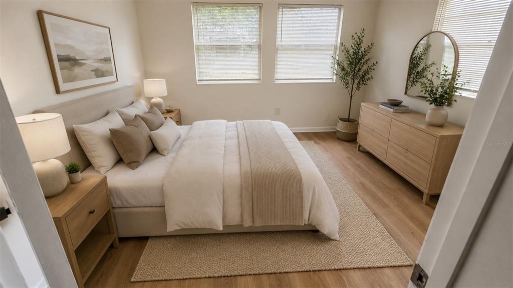 A bedroom features a bed, light wood furniture, a rug, and windows with blinds — 31 S BARBOUR STREET, BEVERLY HILLS, FL