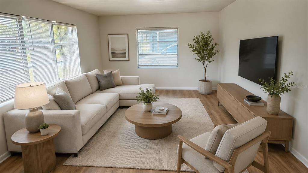 A living room features a sectional sofa, round coffee table, armchair, and wall-mounted television — 31 S BARBOUR STREET, BEVERLY HILLS, FL
