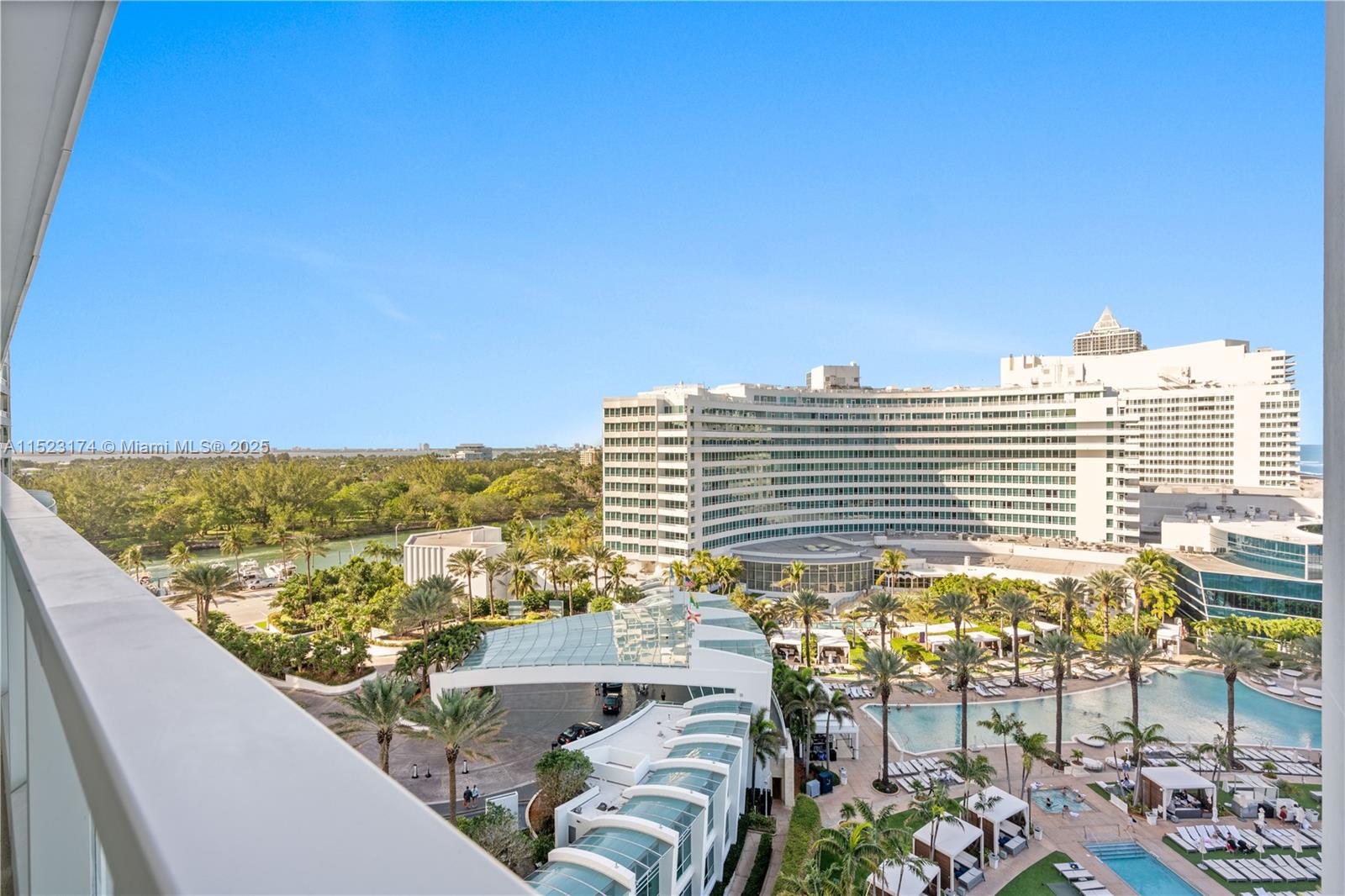 A high-angle view shows a resort hotel with a pool, palm trees, and surrounding greenery — 4391 COLLINS AV # 1007, Miami Beach FL 33140, MIAMI BEACH, FL