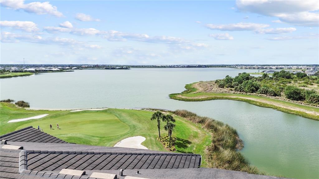 An elevated view shows a golf course green and a lake with surrounding landscape — 43000 GREENWAY BOULEVARD UNIT 145, PUNTA GORDA, FL