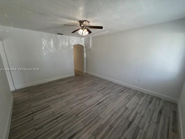 An empty room features white walls, a ceiling fan, and light-colored wood-look tile flooring — 2742 SW 32nd Ave # 2742, Miami FL 33133, MIAMI, FL