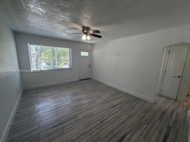 An empty room features white walls, a ceiling fan, and light-colored wood-look tile flooring — 2742 SW 32nd Ave # 2742, Miami FL 33133, MIAMI, FL