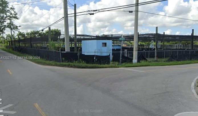 A fenced-in outdoor area features a small blue utility shed and overhead netting — 19490 SW 198TH ST, Miami FL 33187, MIAMI, FL