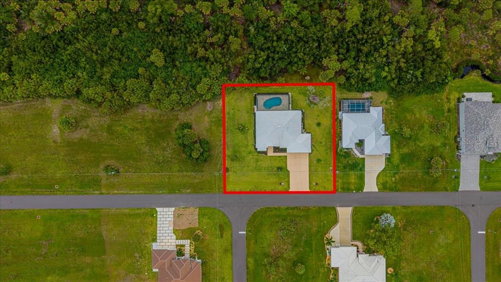 An aerial view shows a single-family home with a backyard pool inside a red border — 16883 ACAPULCO ROAD, PUNTA GORDA, FL