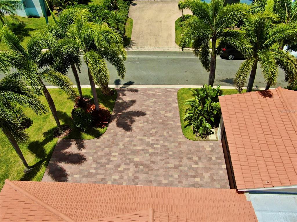 An aerial view shows a paved driveway leading to a house with a tiled roof — 302 CAMINO DE LOS CEDROS, DORADO, PR