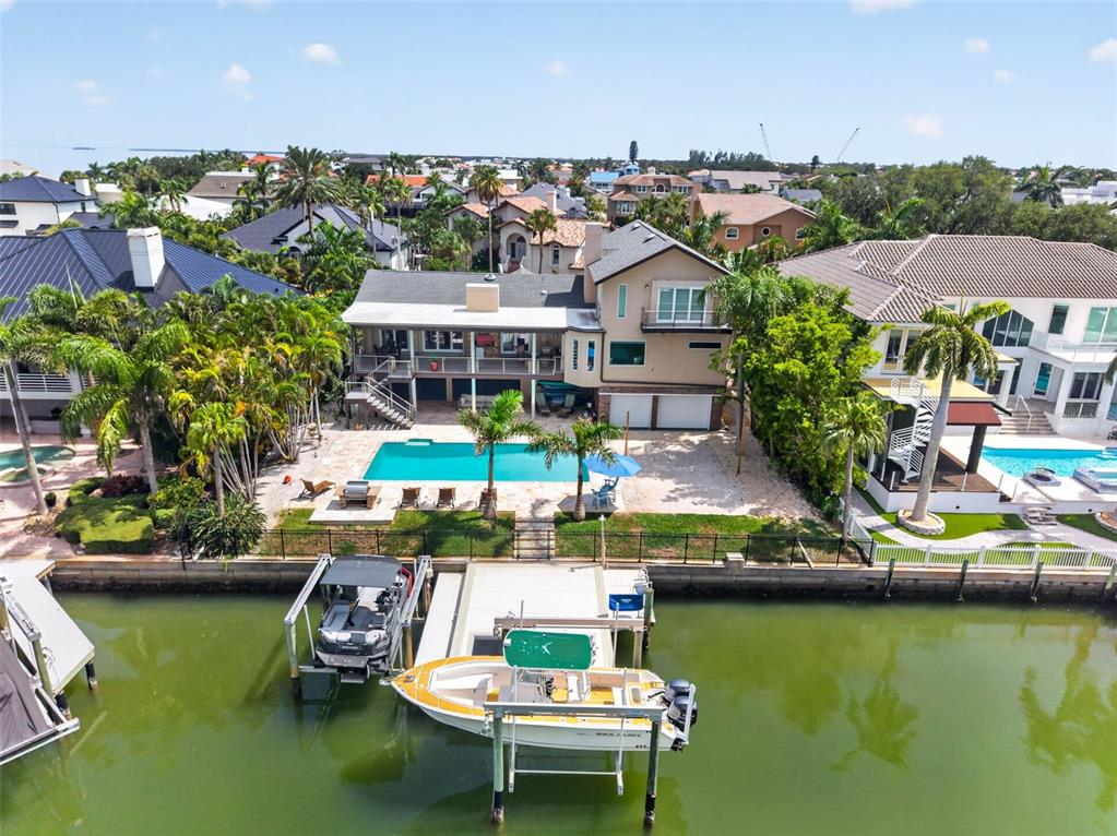 An aerial view shows a waterfront house with a swimming pool and a private boat dock — 113 7TH STREET E, ST PETERSBURG, FL