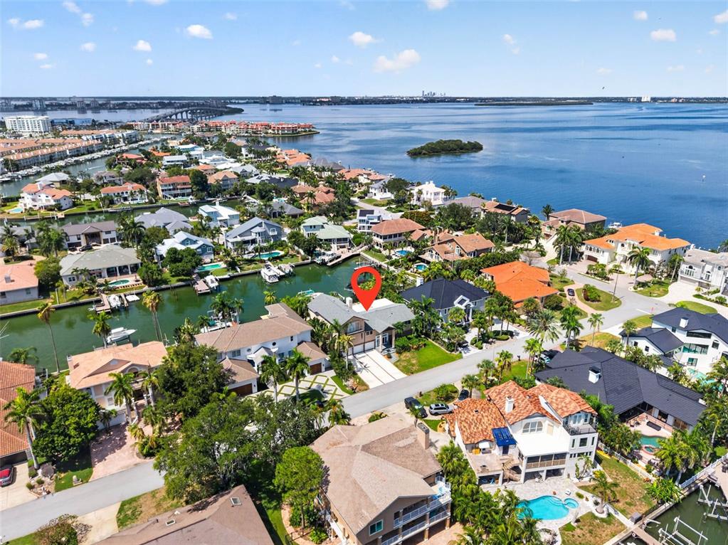 An aerial view shows a waterfront residential neighborhood with a red pin marking a house — 113 7TH STREET E, ST PETERSBURG, FL
