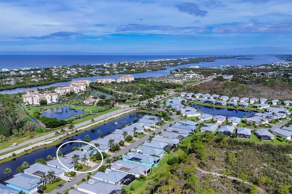 An aerial view shows a residential neighborhood with a circled house near a canal — 10446 COQUINA COURT, PLACIDA, FL
