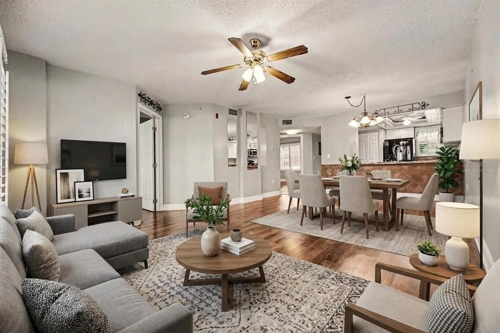 A living and dining room with hardwood floors, a ceiling fan, and neutral furniture — 4250 A1A S UNIT I-16, ST AUGUSTINE, FL
