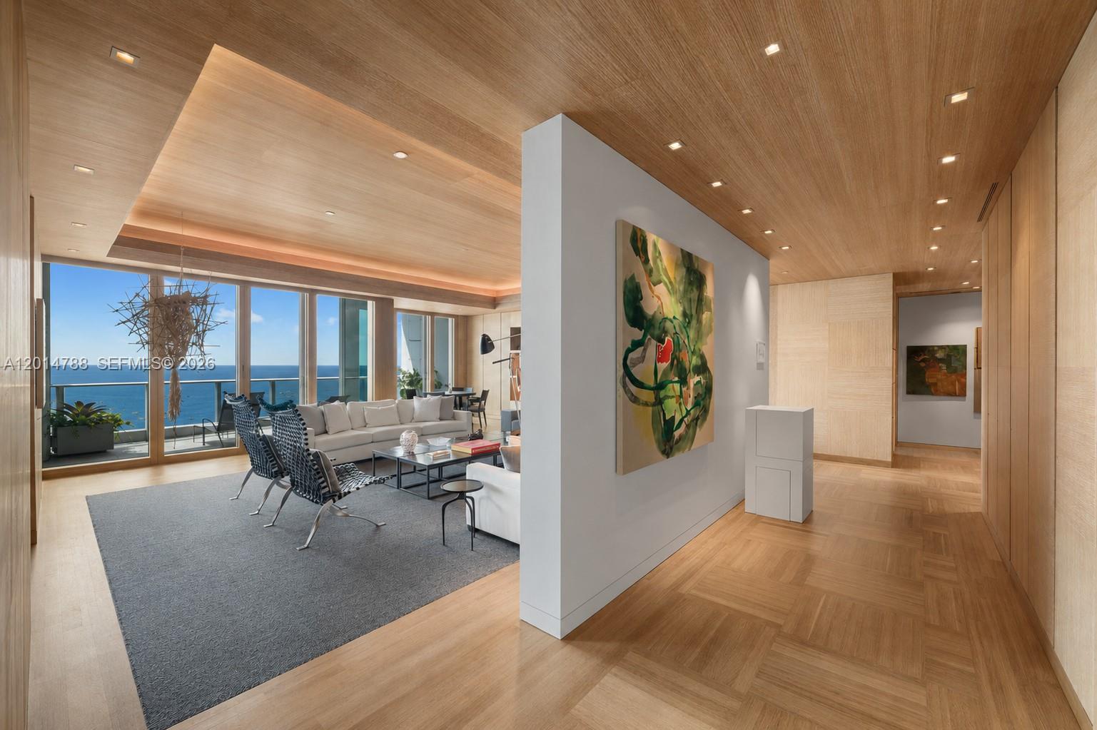 A modern living room with wood-paneled ceilings, a white partition wall, and ocean views — 2627 S Bayshore Dr # 3201, Miami FL 33133, MIAMI, FL