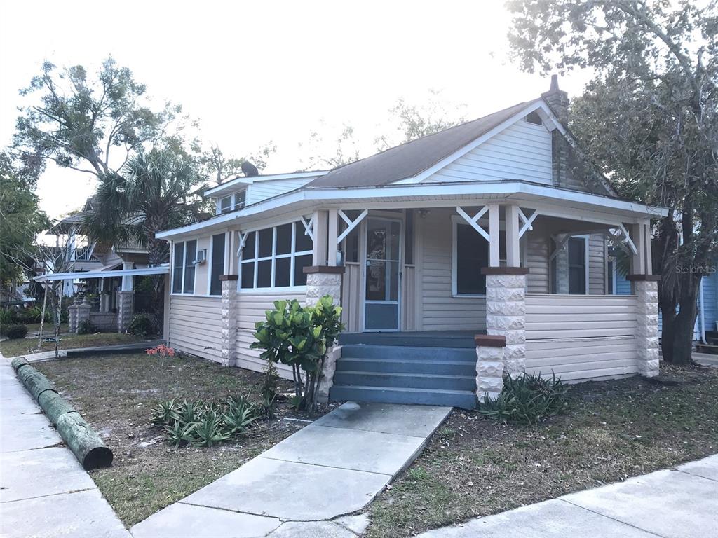 A single-story house with light-colored siding, a front porch, and stone-accented columns — 540 14TH STREET N, ST PETERSBURG, FL