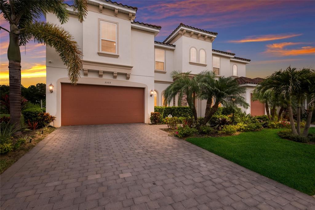 A two-story house with a paved driveway, a two-car garage, and palm trees — 3533 BIG SKY WAY, LAKEWOOD RANCH, FL
