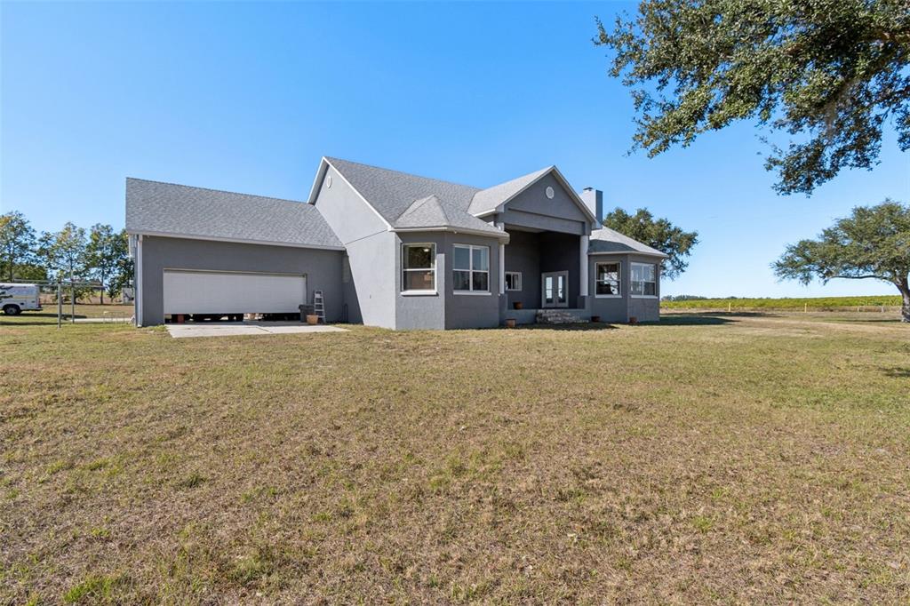 A gray, single-story house with a large garage and a covered front entryway — 2307 CASS ROAD, LAKE ALFRED, FL