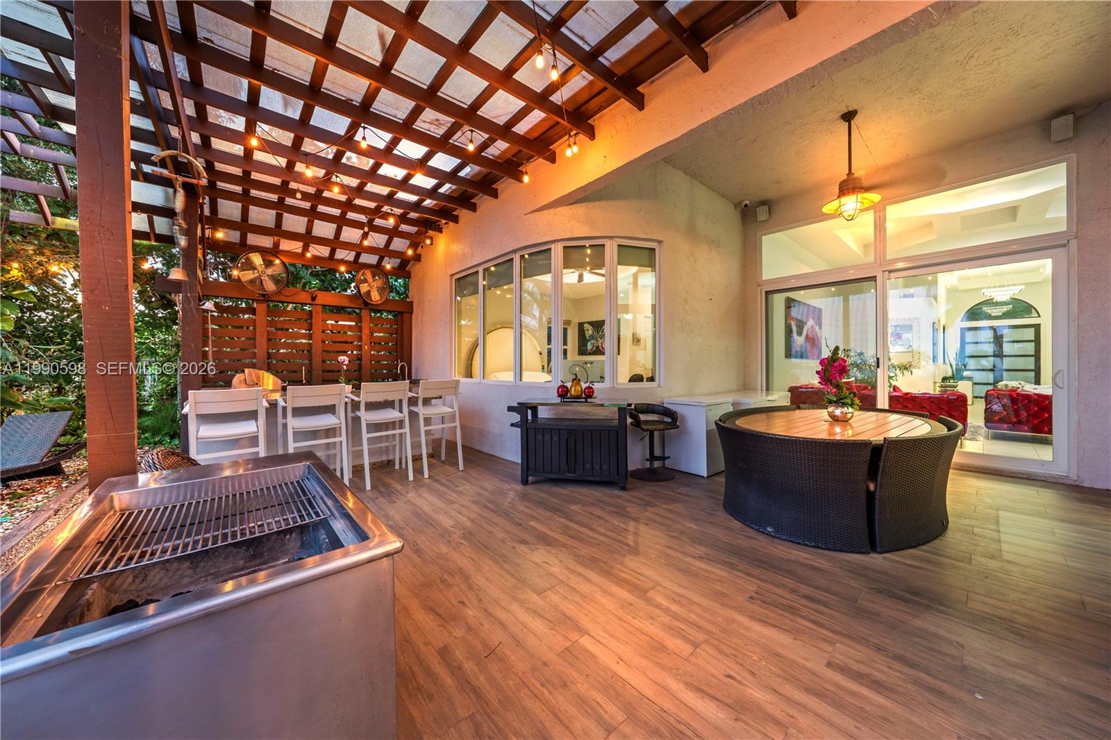 A covered outdoor patio features a grill, dining area, bar seating, and wood-look flooring — 5265 SW 171st Ave, Miramar FL 33027, MIRAMAR, FL