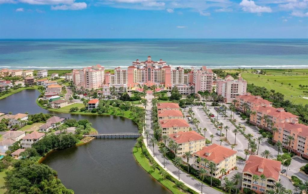 An aerial view of a large coastal resort complex with a lake and parking lot — 200 OCEAN CREST DRIVE UNIT 325, PALM COAST, FL