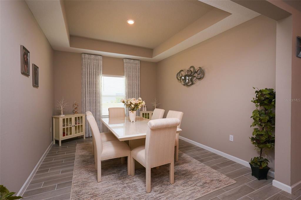 A front entryway features a dark door, a stone archway, and light blue siding — 9332 SW 58TH CIRCLE, OCALA, FL