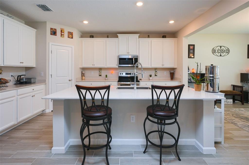 A dining room features a rectangular table, six upholstered chairs, and a tray ceiling — 9332 SW 58TH CIRCLE, OCALA, FL