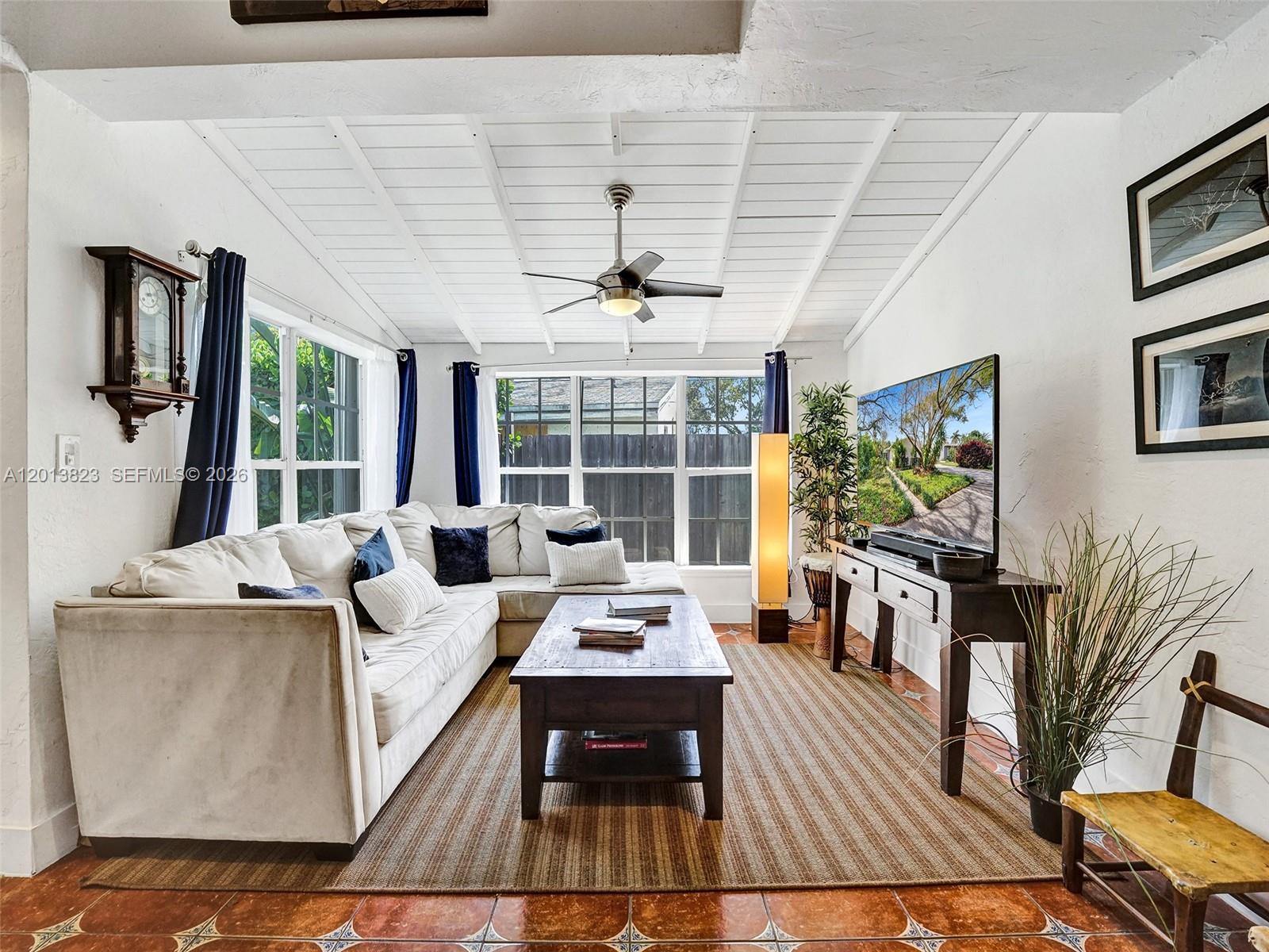 A living room features a white sectional sofa, a wooden coffee table, and a ceiling fan — 918 NE 4th Court, Hallandale Beach FL 33009, HALLANDALE BEACH, FL