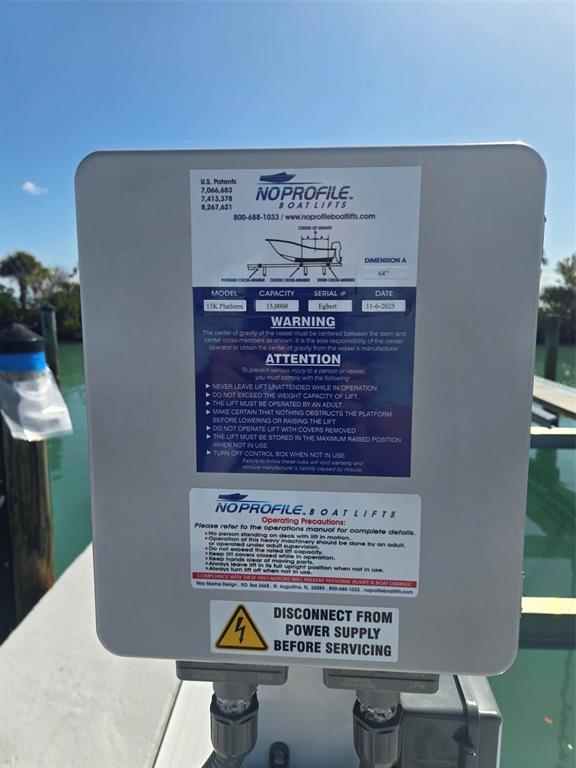 A close-up view of a No Profile boat lift control box mounted on a dock — 5820 GASPARILLA ROAD UNIT SLIP 25, BOCA GRANDE, FL