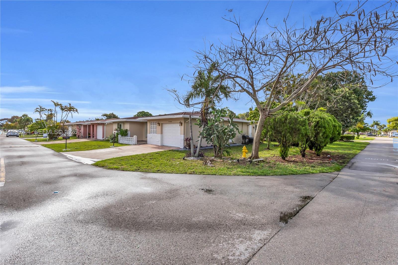 A single-story house with a white garage and a front yard featuring a fire hydrant — 1280 NW 49th St, Deerfield Beach FL 33064, DEERFIELD BEACH, FL