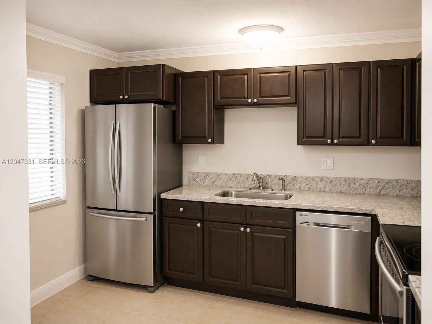A kitchen features dark wood cabinets, stainless steel appliances, and light granite countertops — 331 Lakeview Dr # 203, Weston FL 33326, WESTON, FL